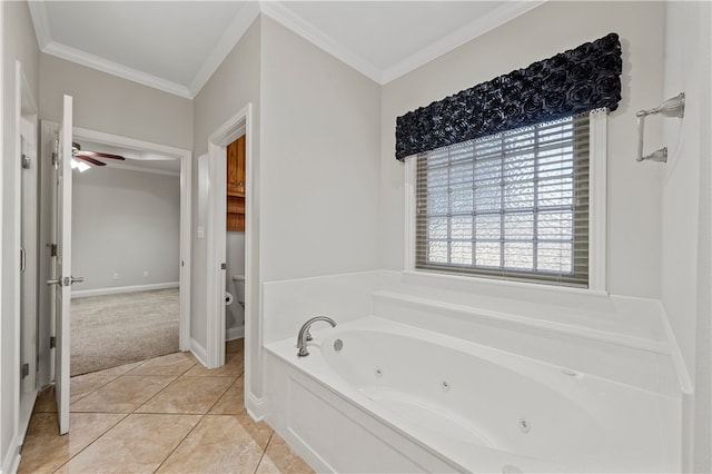 bathroom with tile patterned flooring, ornamental molding, ceiling fan, and a bathing tub