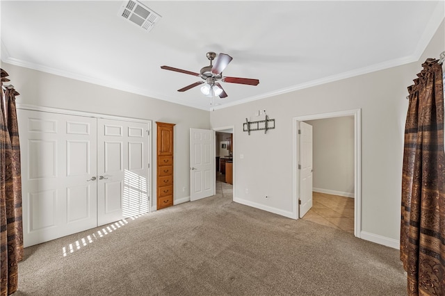 unfurnished bedroom with light colored carpet, ceiling fan, and crown molding