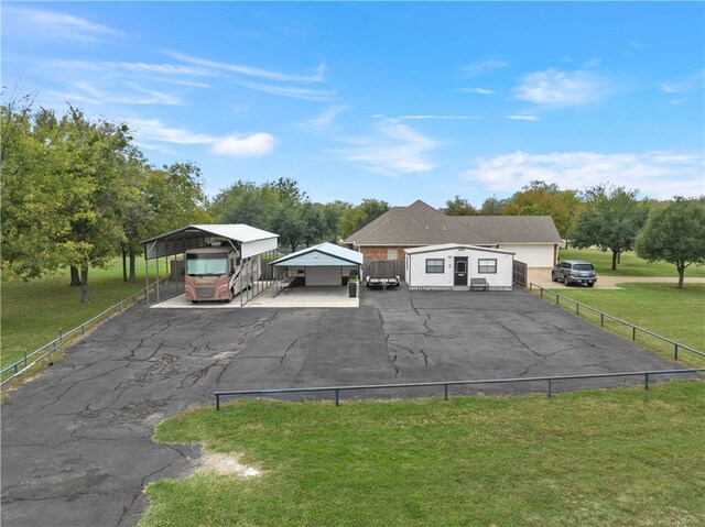 view of parking featuring a carport and a lawn