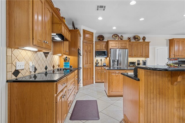 kitchen featuring stainless steel appliances, a kitchen island, crown molding, light tile patterned flooring, and exhaust hood