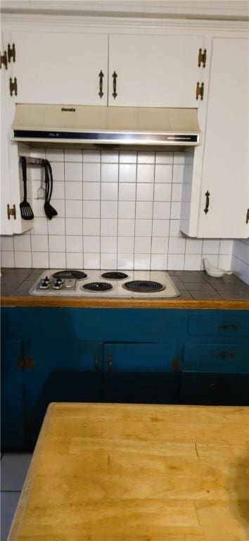 kitchen featuring white cabinets, white gas stovetop, backsplash, and tile countertops