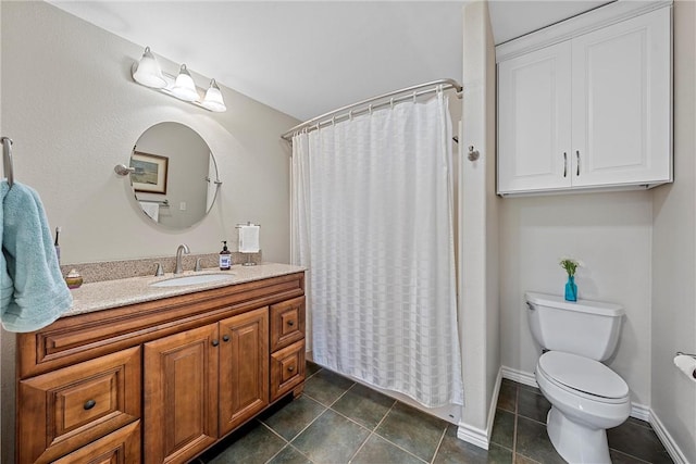 bathroom featuring toilet, vanity, tile patterned floors, and walk in shower