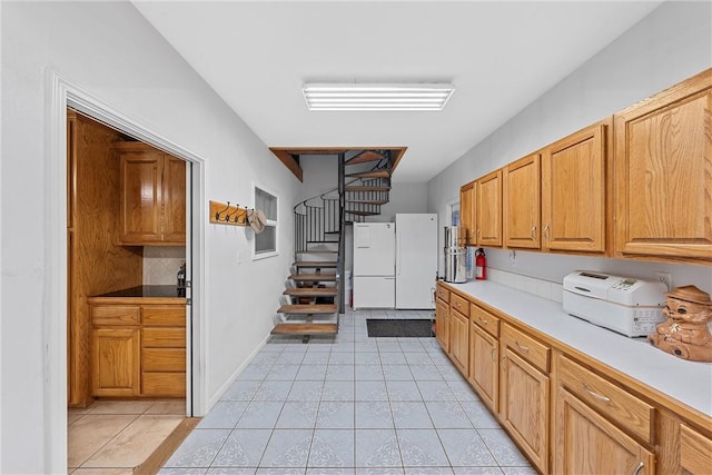 kitchen featuring white refrigerator and light tile patterned floors