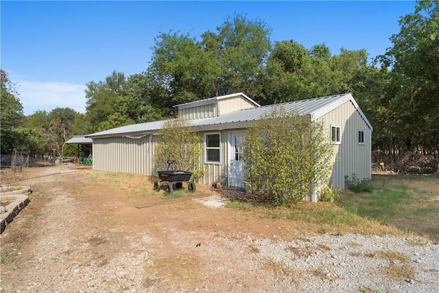 back of property with a carport