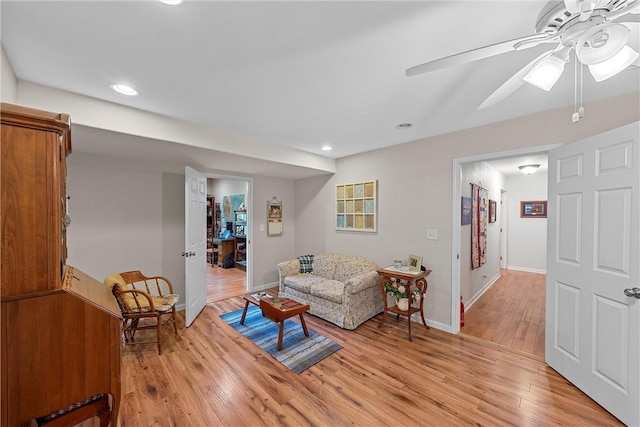 living room featuring ceiling fan and light wood-type flooring