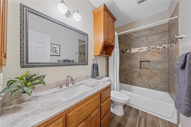 full bathroom featuring shower / bath combo with shower curtain, vanity, wood-type flooring, and toilet