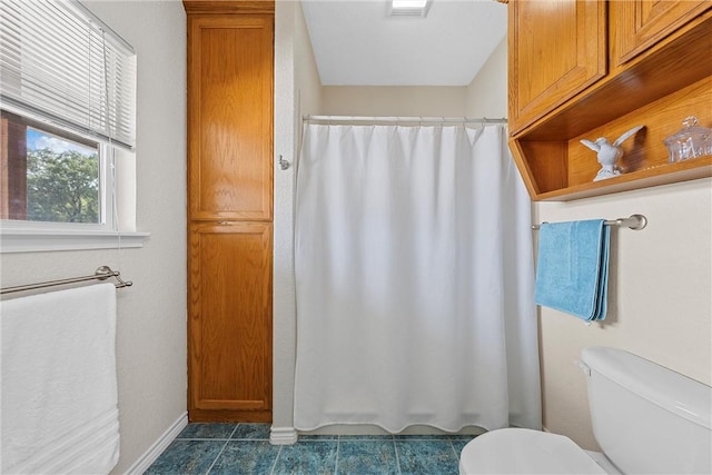 bathroom featuring toilet and tile patterned floors