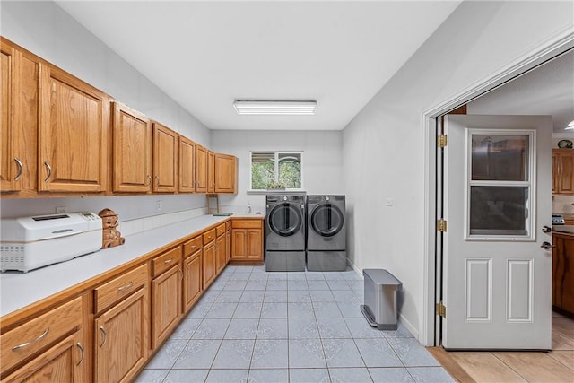 washroom featuring washer and clothes dryer, light tile patterned flooring, and sink