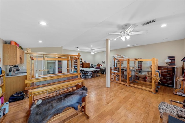 miscellaneous room featuring ceiling fan, lofted ceiling, and light wood-type flooring