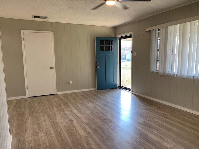 foyer with hardwood / wood-style floors, a textured ceiling, and a healthy amount of sunlight