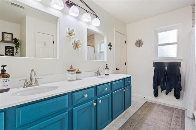 bathroom with tile patterned flooring and vanity