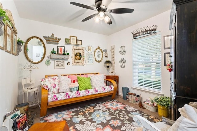 sitting room with hardwood / wood-style flooring and ceiling fan