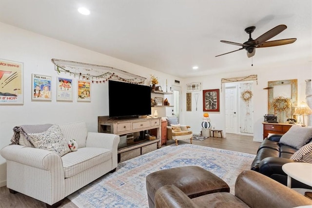 living room featuring hardwood / wood-style flooring and ceiling fan