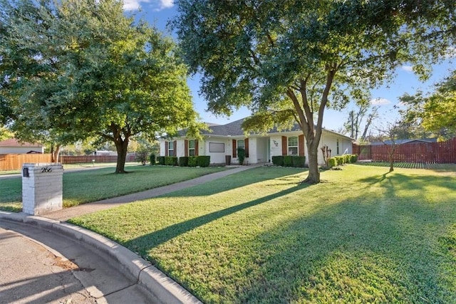 ranch-style home with a front lawn