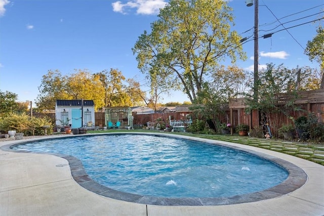 view of swimming pool with a storage shed