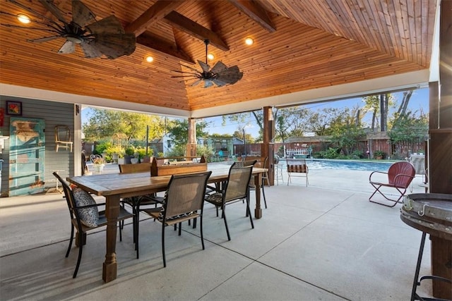 view of patio featuring a fenced in pool and ceiling fan