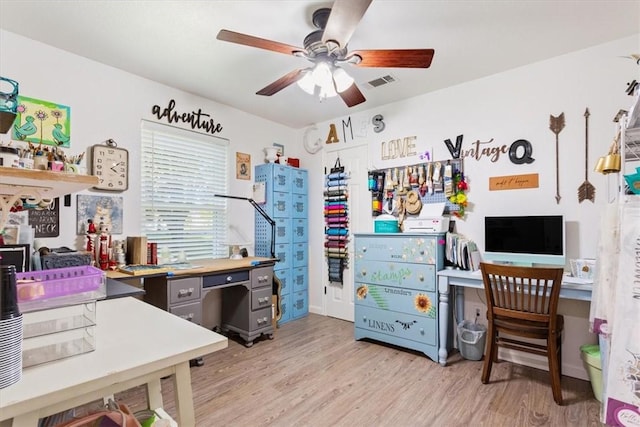 office space featuring ceiling fan and light hardwood / wood-style flooring