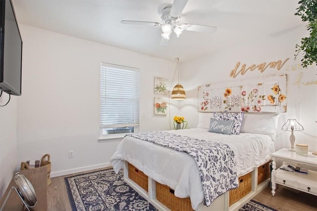 bedroom featuring ceiling fan and dark wood-type flooring