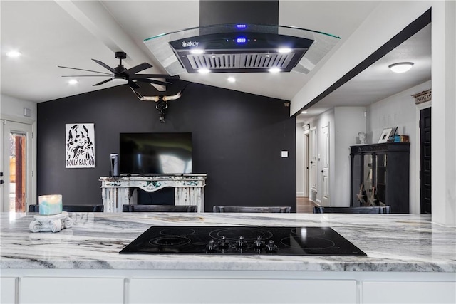 kitchen with light stone countertops, island exhaust hood, vaulted ceiling, black electric cooktop, and white cabinets