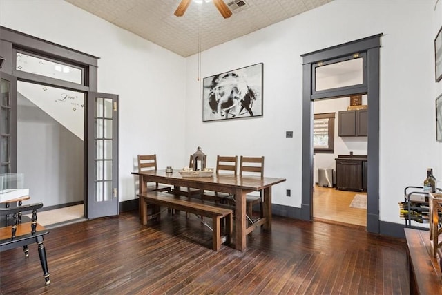 dining space featuring ceiling fan, dark wood-type flooring, and french doors