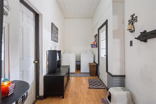 hallway featuring light hardwood / wood-style floors and separate washer and dryer