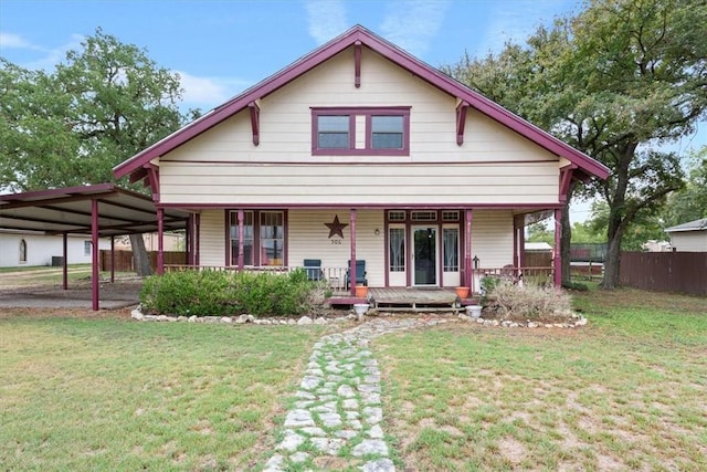 view of front of home featuring a front lawn, covered porch, and a carport