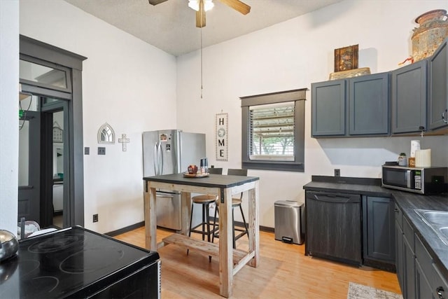 kitchen with sink, light hardwood / wood-style flooring, ceiling fan, and black appliances