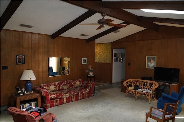 carpeted living room featuring vaulted ceiling with beams, wooden walls, and ceiling fan