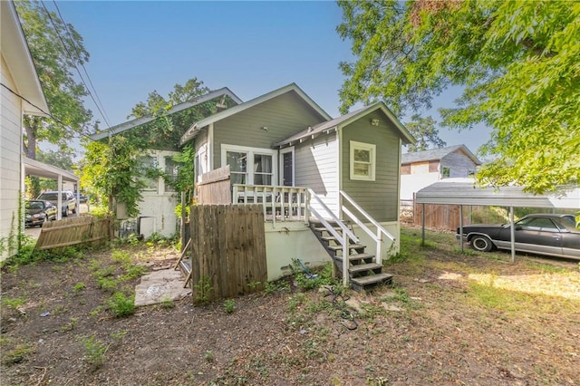 rear view of property featuring a carport