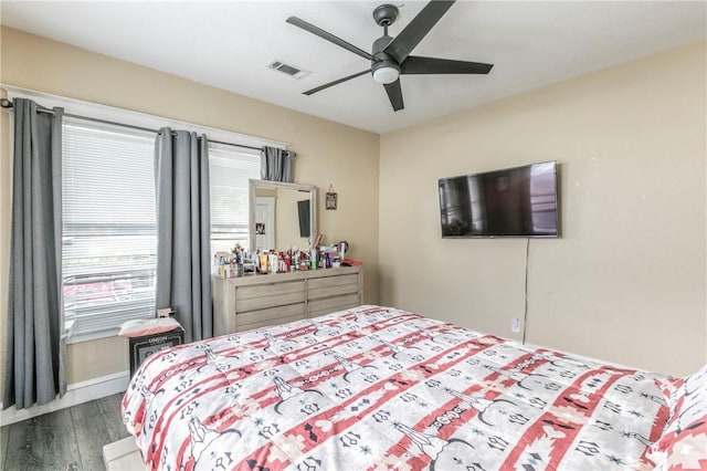 bedroom featuring ceiling fan and dark hardwood / wood-style floors