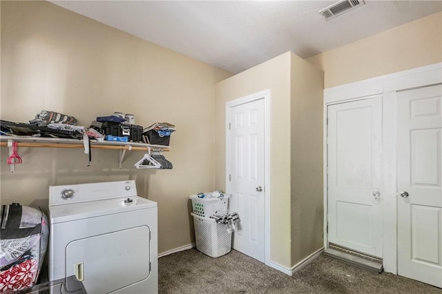 washroom with dark colored carpet and washer / dryer