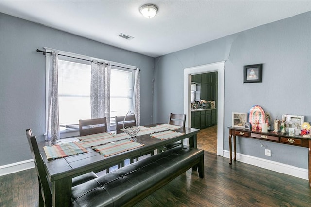 dining area with dark hardwood / wood-style floors