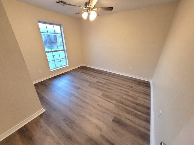 spare room with dark wood-type flooring and ceiling fan