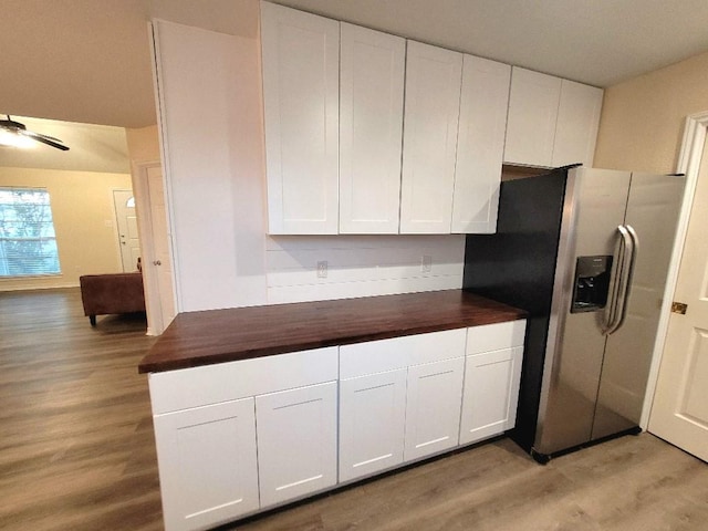 kitchen featuring white cabinetry, stainless steel refrigerator with ice dispenser, butcher block counters, and light hardwood / wood-style flooring