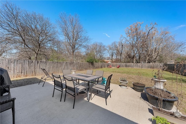 view of patio featuring a fenced backyard and outdoor dining area