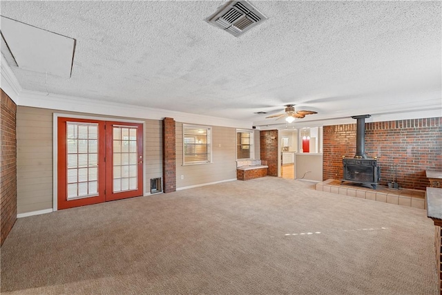 unfurnished living room with ceiling fan, carpet floors, and a textured ceiling