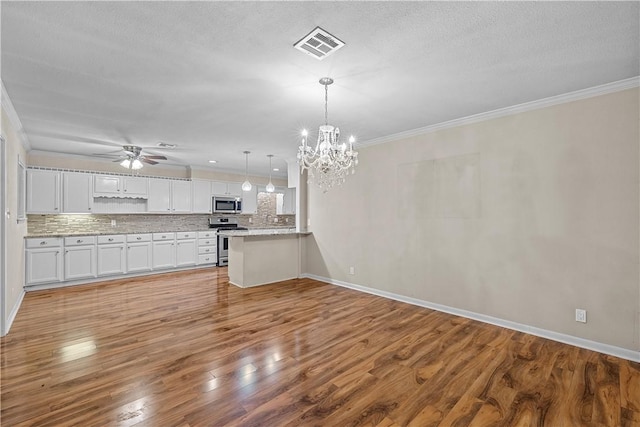 kitchen featuring white cabinets, hanging light fixtures, light hardwood / wood-style flooring, kitchen peninsula, and stainless steel appliances