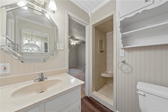 bathroom with hardwood / wood-style floors, vanity, ceiling fan, toilet, and ornamental molding