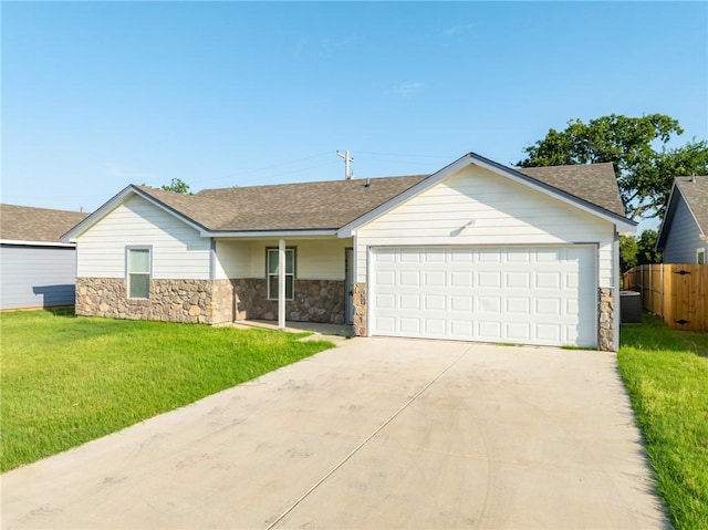 single story home featuring central air condition unit, a front lawn, and a garage