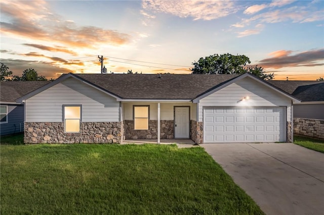 ranch-style home with a garage and a yard