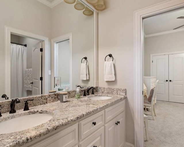 bathroom with ornamental molding and vanity