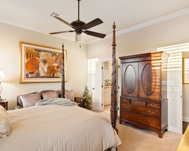 bedroom with ornamental molding, connected bathroom, light carpet, and ceiling fan