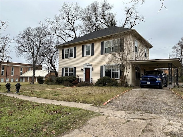 view of front of house with a carport, a front lawn, and gravel driveway