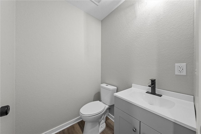 bathroom featuring hardwood / wood-style flooring, vanity, and toilet