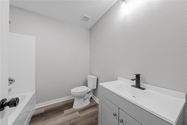 full bathroom with vanity, toilet, wood-type flooring, and shower / tub combination