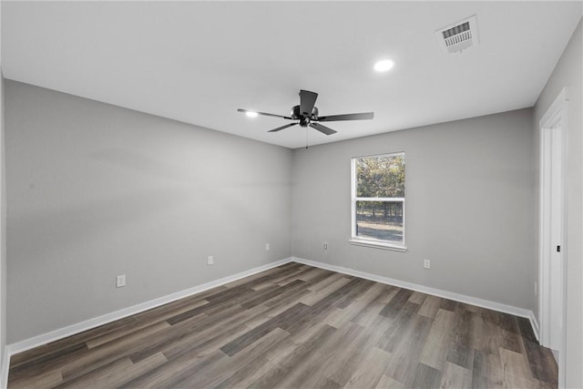 unfurnished room with ceiling fan and dark wood-type flooring