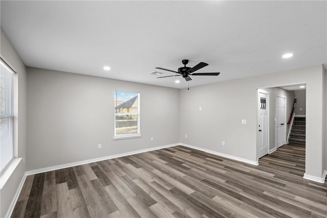 empty room with ceiling fan and dark hardwood / wood-style floors