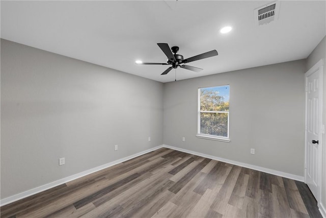 unfurnished room featuring ceiling fan and dark hardwood / wood-style flooring