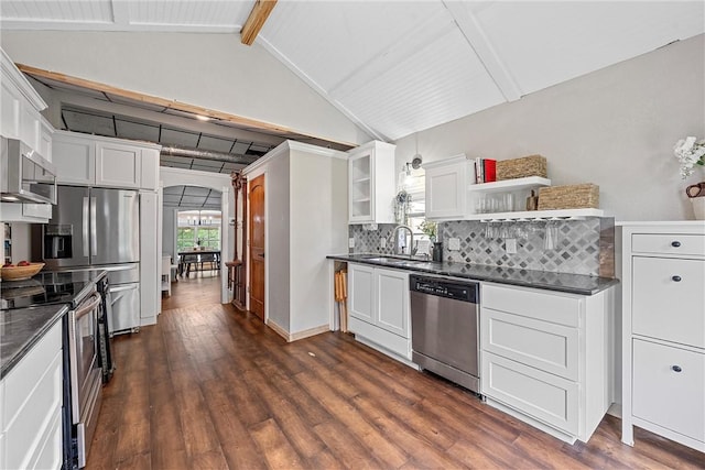 kitchen with white cabinets, dark hardwood / wood-style flooring, lofted ceiling with beams, and stainless steel appliances