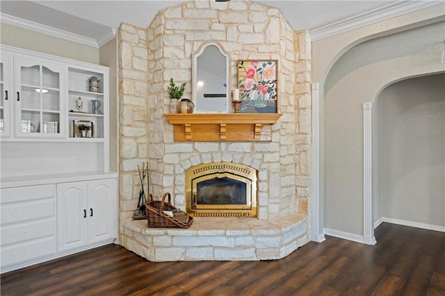 unfurnished living room featuring a fireplace, dark hardwood / wood-style flooring, and ornamental molding